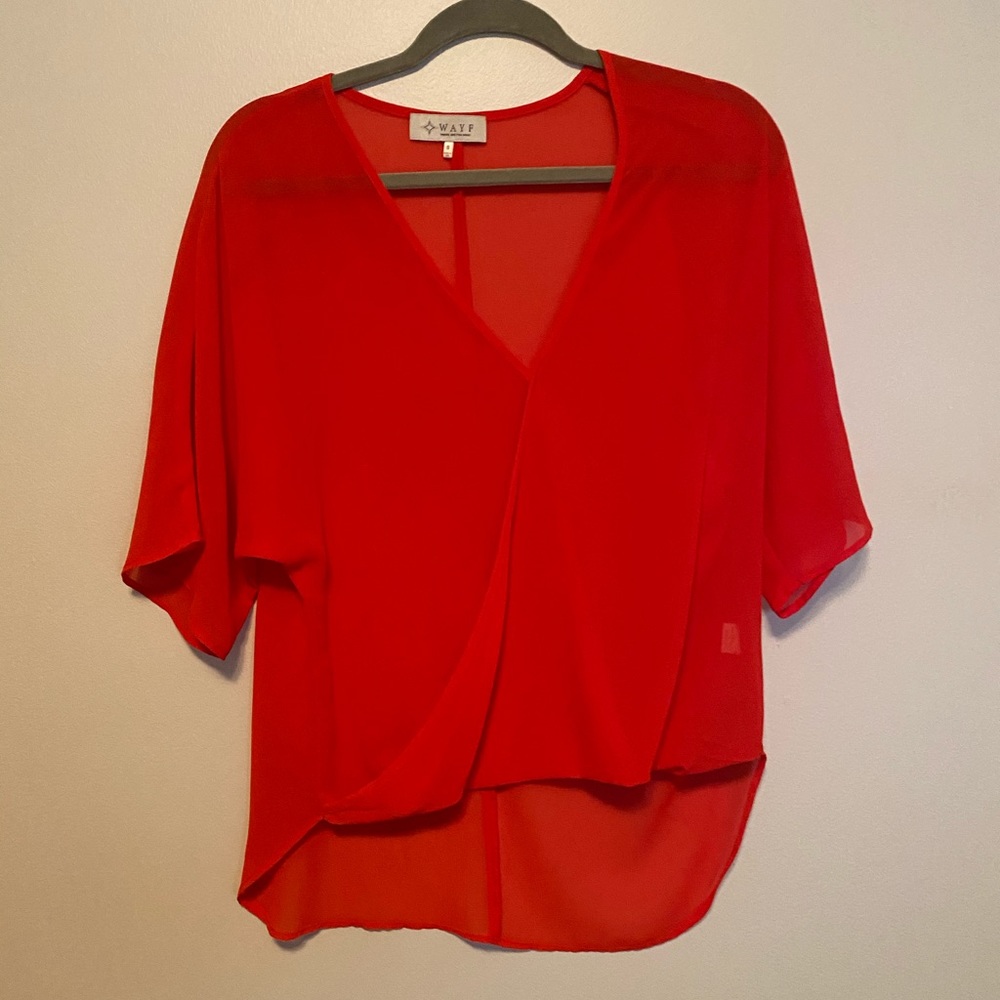 Cute red top! Would go great with black jeans!